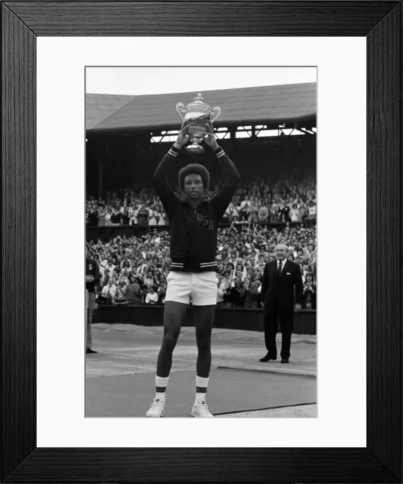 Framed Print : Arthur Ashe with the Wimbledon trophy after he beat the defending champion Jimmy Connors Framed Print : Arthur Ashe with the Wimbledon trophy after he beat the defending champion Jimmy Connors