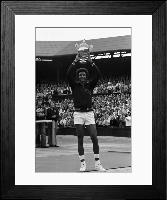 Framed Print : Arthur Ashe with the Wimbledon trophy after he beat the defending champion Jimmy Connors Framed Print : Arthur Ashe with the Wimbledon trophy after he beat the defending champion Jimmy Connors