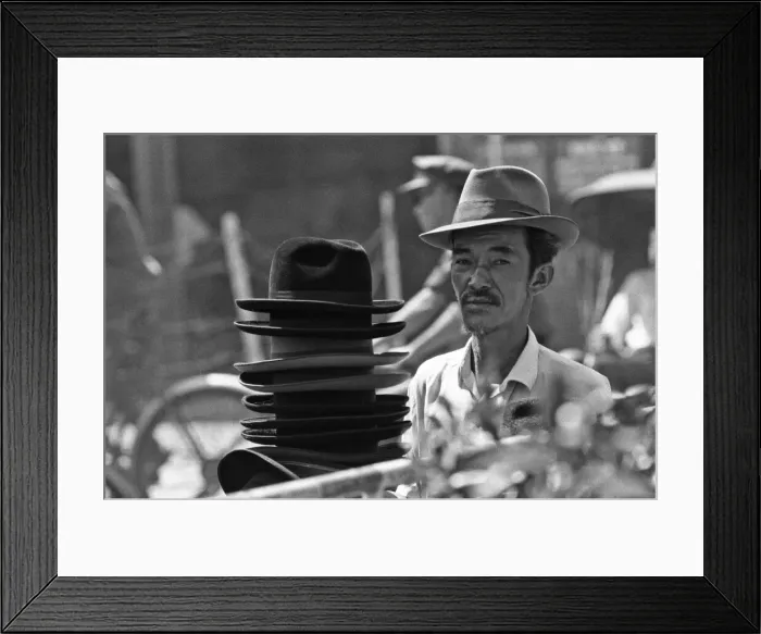 Framed Print : Hat seller at the flower market in Saigon on the eve of the Tet celebrations Framed Print : Hat seller at the flower market in Saigon on the eve of the Tet celebrations