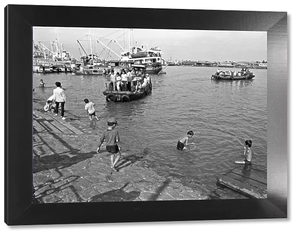 Children swimming in the Saigon River on the eve of Tet, the Vietnamese new year