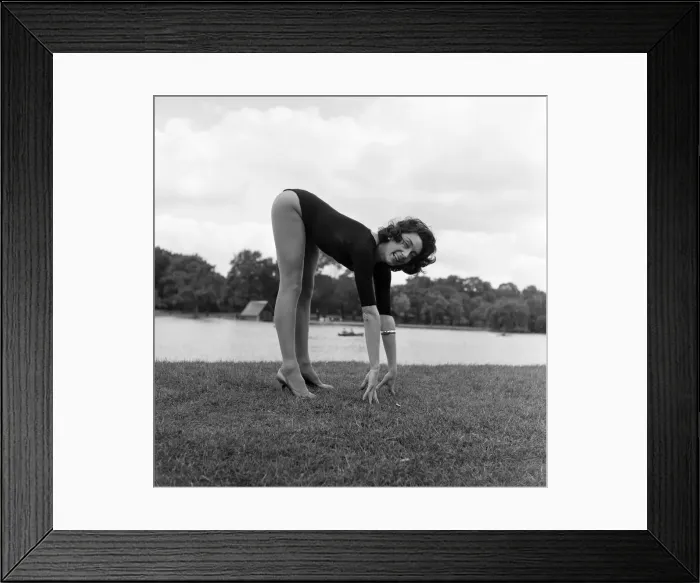 Framed Print : Dancer Gillian Lynne has her own idea of a sitting position whilst taking the sun Framed Print : Dancer Gillian Lynne has her own idea of a sitting position whilst taking the sun
