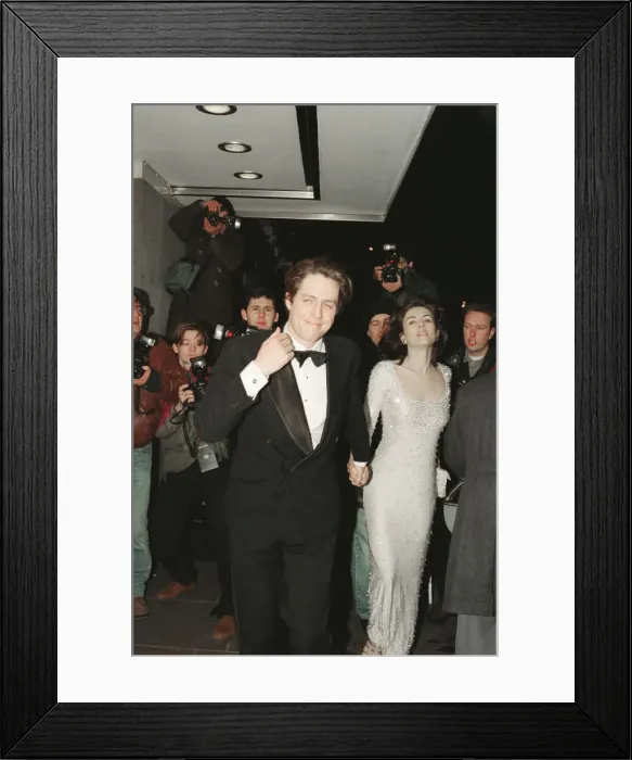 Framed Print : Hugh Grant and his girlfriend, model and actor Elizabeth Hurley arrive for The London