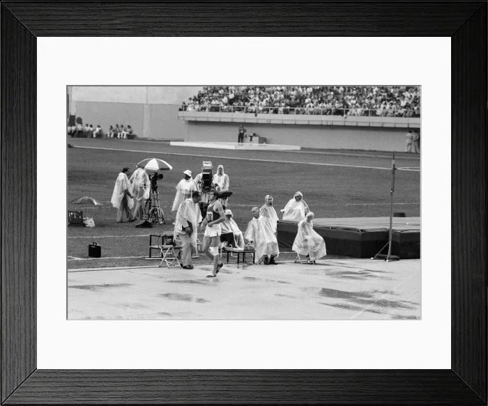 Framed Print : The 1976 Summer Olympics in Montreal, Canada. Pictured, track officials under plastic Framed Print : The 1976 Summer Olympics in Montreal, Canada. Pictured, track officials under plastic