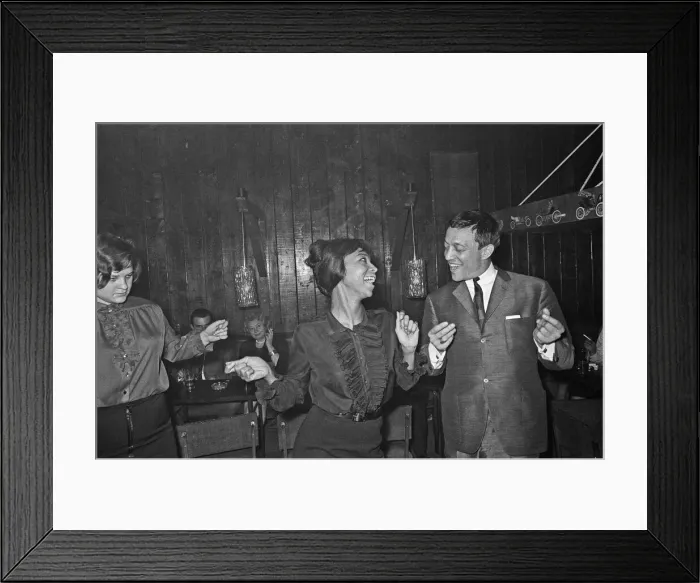 Framed Print : Playboy, film maker and night club owner Rolf Eden, seen here dancing with one of Framed Print : Playboy, film maker and night club owner Rolf Eden, seen here dancing with one of
