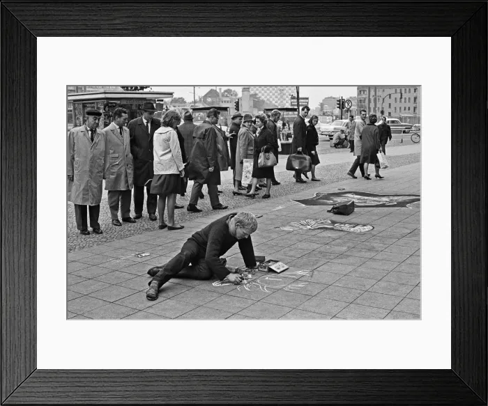 Framed Print : Passers by stop and admire the work of a street artist, who uses the pavements of