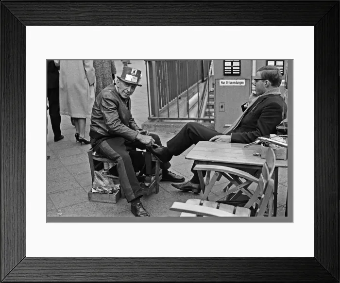 Framed Print : A Shoe Shine goes to work on a clients shoes close to the underground station Framed Print : A Shoe Shine goes to work on a clients shoes close to the underground station