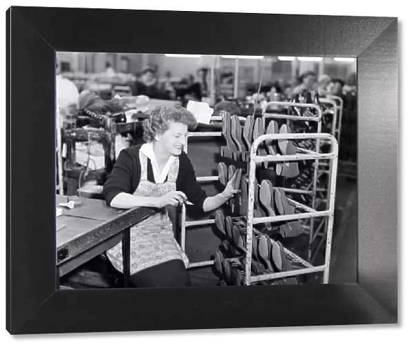 A worker at the Mansfield shoe factory in Northampton seen here trimming shoes 26th April