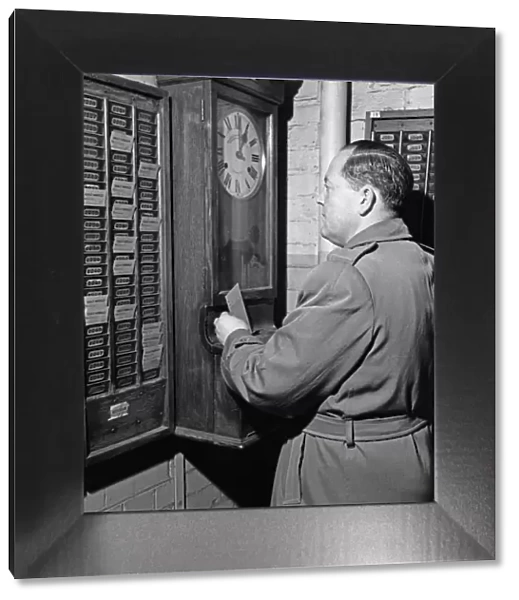 Clocking on at the Daily Herald newspaper offices. 18th December 1959