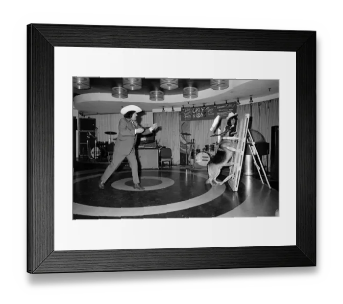 Framed Print : A knife throwing act which uses a dog as part of its show. 1972 Framed Print : A knife throwing act which uses a dog as part of its show. 1972