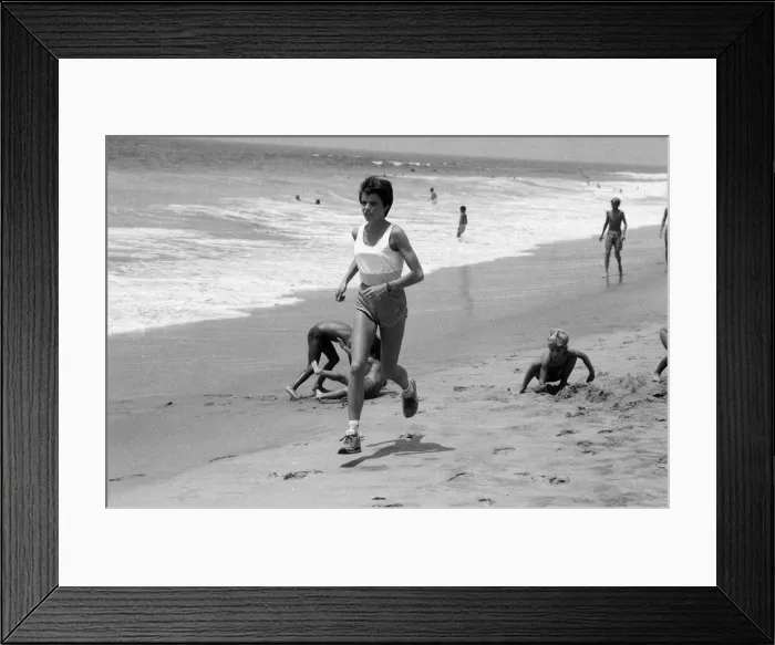 Framed Print : The 1984 Summer Olympics in Los Angeles. Wendy Sly running on Manhattan Beach, California Framed Print : The 1984 Summer Olympics in Los Angeles. Wendy Sly running on Manhattan Beach, California