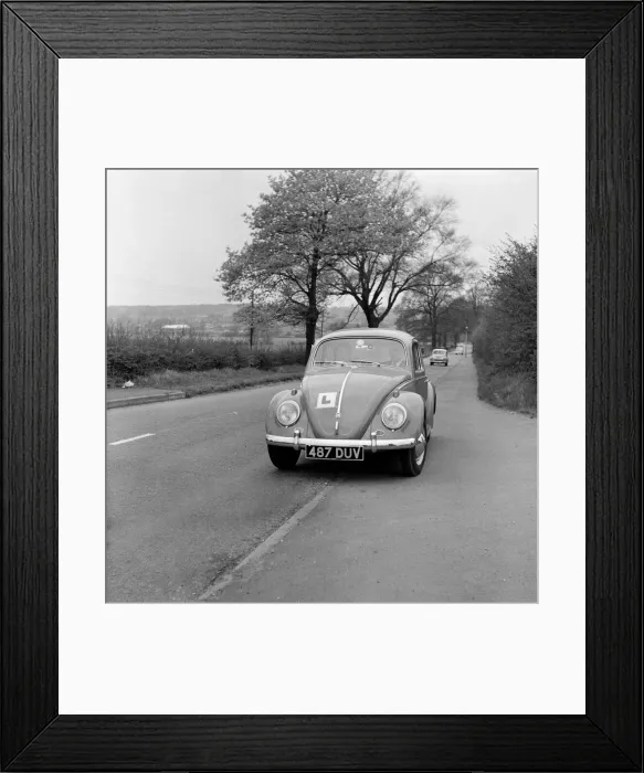 Framed Print : Learner driver in a Volkswagen Beetle. May 1962 Framed Print : Learner driver in a Volkswagen Beetle. May 1962