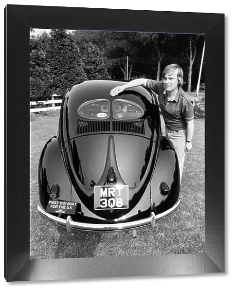 A man poses with a Volkswagen Beetle. 2nd June 1982