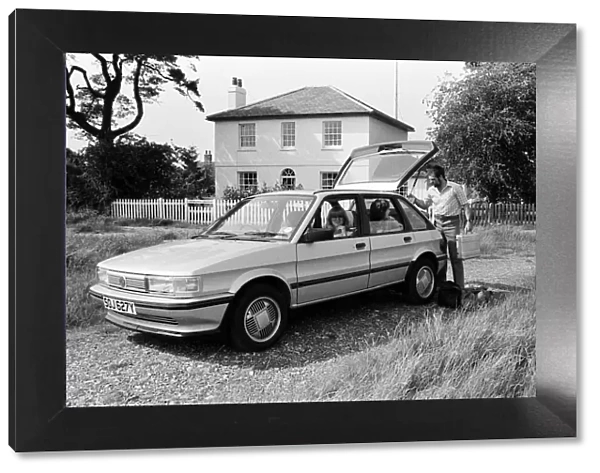 A man, woman and girl with a MG Maestro. 8th June 1983