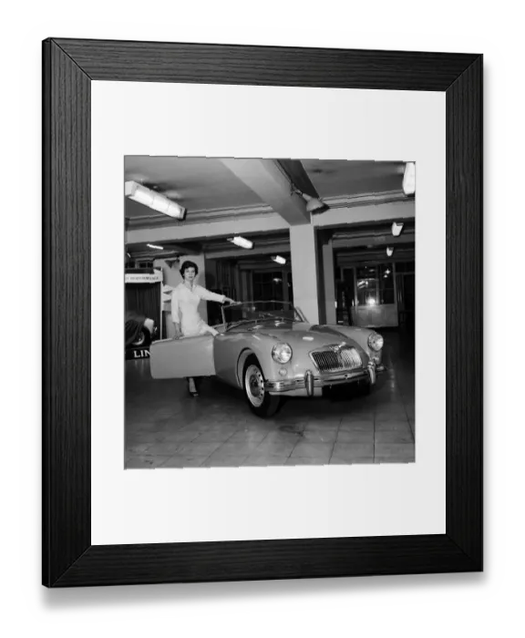 Framed Print : A new MG car on display in a showroom. 22nd September 1955 Framed Print : A new MG car on display in a showroom. 22nd September 1955