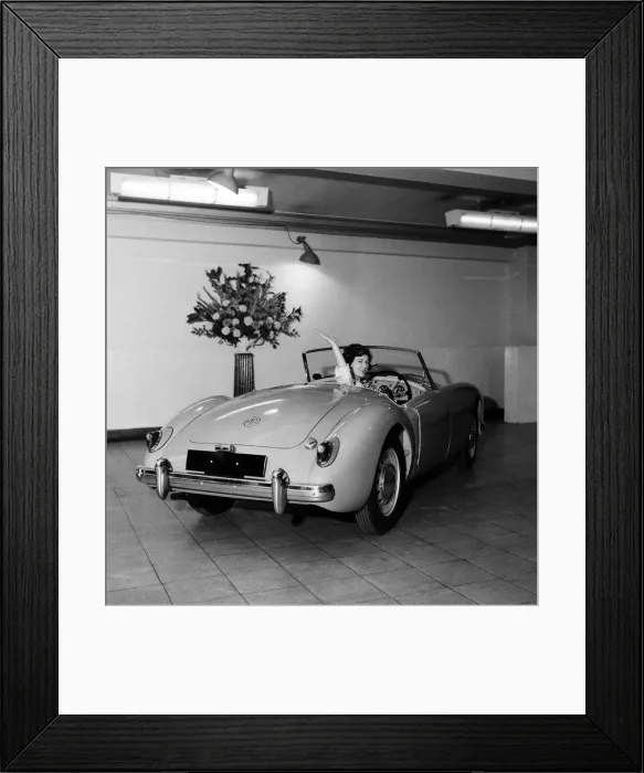 Framed Print : A new MG car on display in a showroom. 22nd September 1955