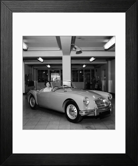 Framed Print : A new MG car on display in a showroom. 22nd September 1955