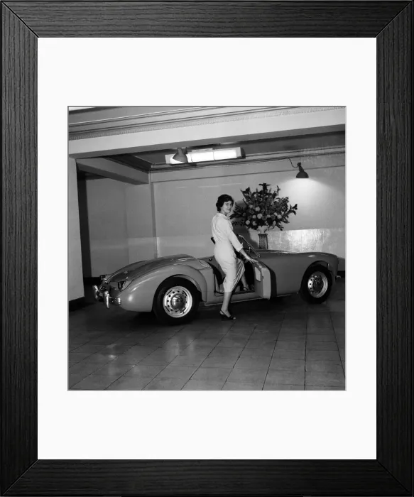 Framed Print : A new MG car on display in a showroom. 22nd September 1955 Framed Print : A new MG car on display in a showroom. 22nd September 1955