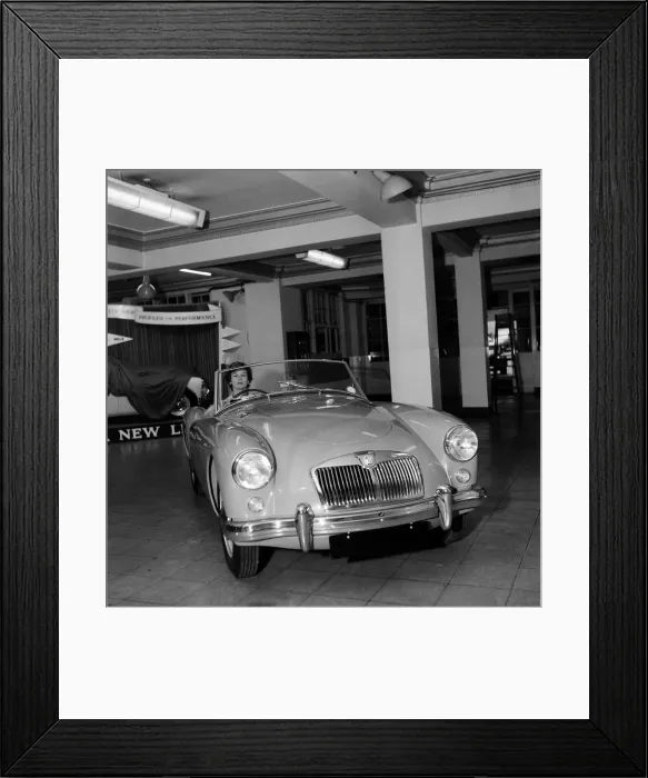 Framed Print : A new MG car on display in a showroom. 22nd September 1955 Framed Print : A new MG car on display in a showroom. 22nd September 1955