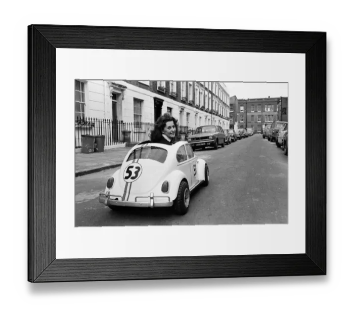Framed Print : Sian Lloyd, who works at Walt Disney Productions, driving a replica of Herbie in Primrose Framed Print : Sian Lloyd, who works at Walt Disney Productions, driving a replica of Herbie in Primrose