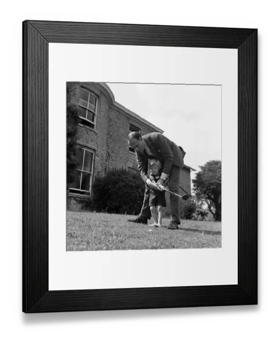 Framed Print : Brigadier Fitzroy Maclean playing with his son Charles in their garden at home in Yealand Framed Print : Brigadier Fitzroy Maclean playing with his son Charles in their garden at home in Yealand