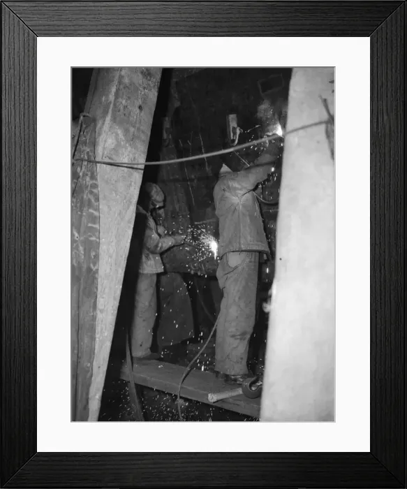 Framed Print : Shipbuilders at the King George V dry dock in Southampton replace damaged hull plates of Framed Print : Shipbuilders at the King George V dry dock in Southampton replace damaged hull plates of