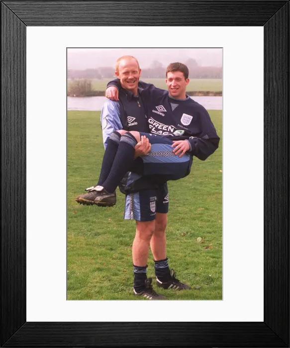 Framed Print : Liverpool defender Mark Wright carries his fellow club teammate Robbie Fowler in his Framed Print : Liverpool defender Mark Wright carries his fellow club teammate Robbie Fowler in his