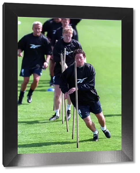 Robbie Fowler leads his teammates during a Liverpool training session