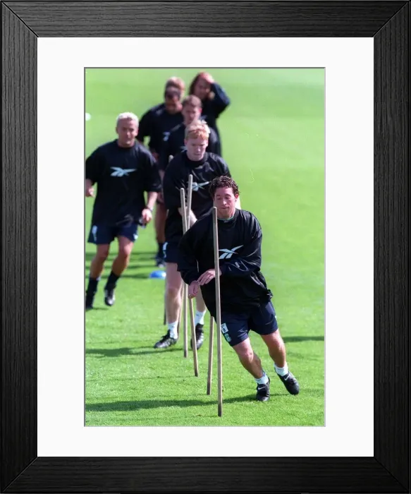 Framed Print : Robbie Fowler leads his teammates during a Liverpool training session Framed Print : Robbie Fowler leads his teammates during a Liverpool training session