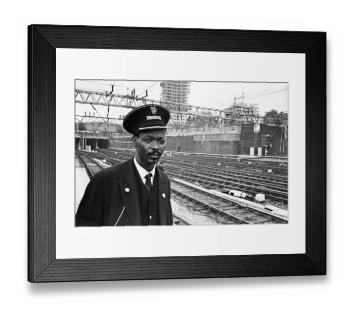 Framed Print : Asquith Xavier in his new job as a guard at Euston Station, London