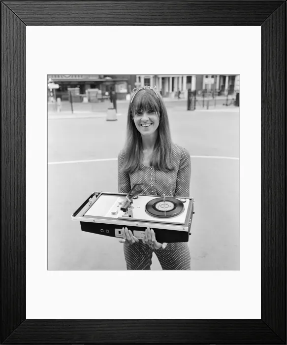 Framed Print : Picture shows The Ready Steady Go TV pop show presenter Cathy McGowan holding a Framed Print : Picture shows The Ready Steady Go TV pop show presenter Cathy McGowan holding a