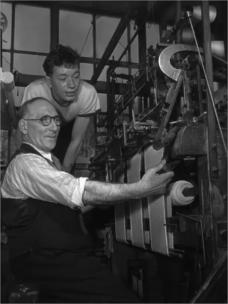 A handframe knitter seen here with his apprentice at The Shawl Factory of GH Hurt