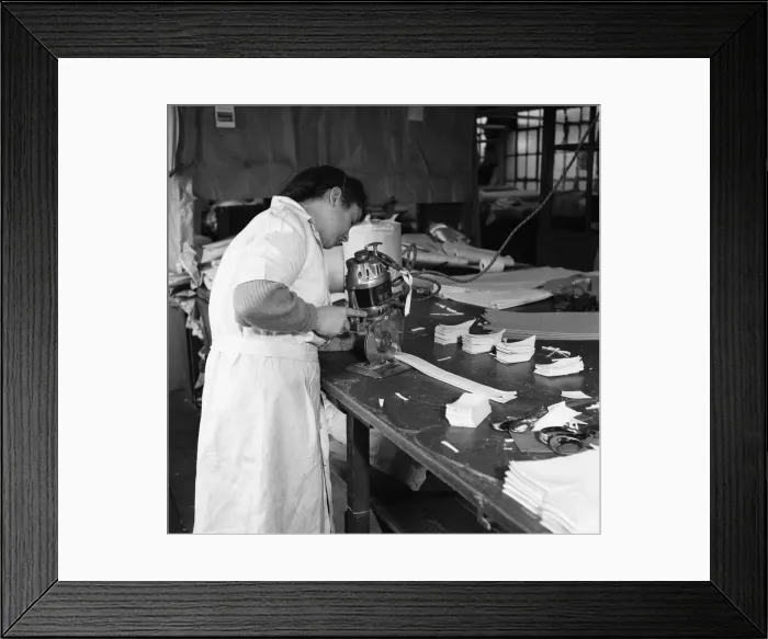 Framed Print : Latex being cut for straps for corsets and girdles at the Spirella Corset factory in