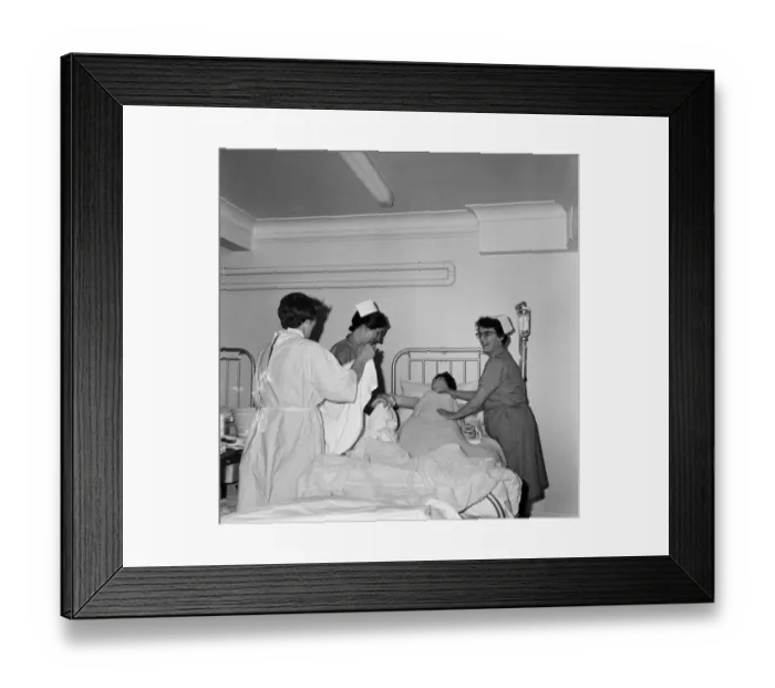 Framed Print : Nurses receiving instruction from Miss V Thomas (in surgical gown) on patient care Framed Print : Nurses receiving instruction from Miss V Thomas (in surgical gown) on patient care