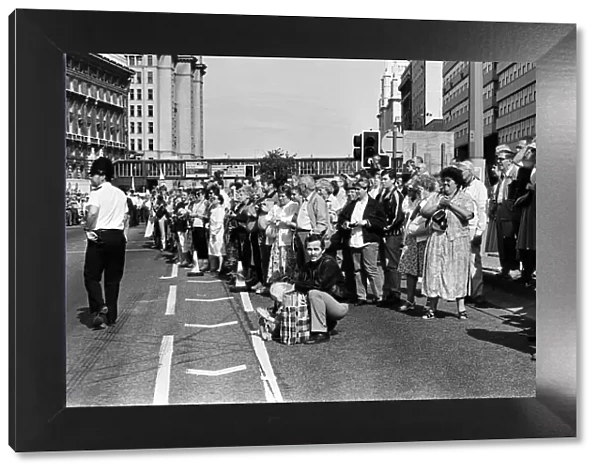 Crowds of people line the dock road set for a day out at Liverpool Albert Dock to see