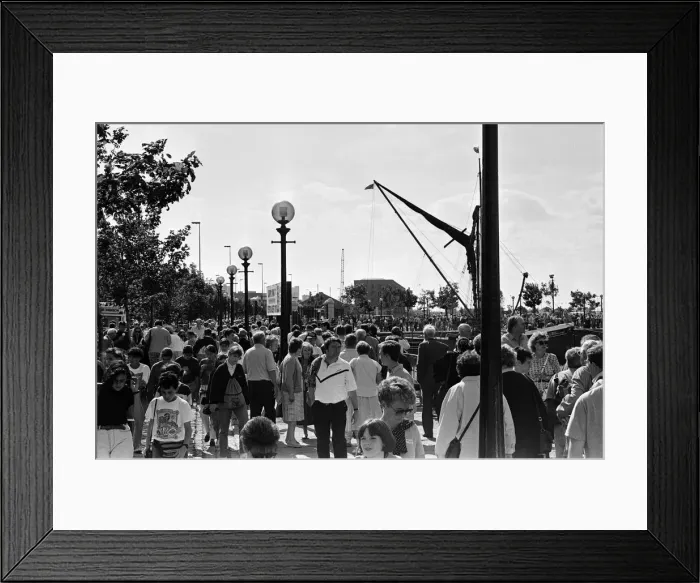 Framed Print : Crowds of people line the dock road set for a day out at Liverpool Albert Dock to see Framed Print : Crowds of people line the dock road set for a day out at Liverpool Albert Dock to see
