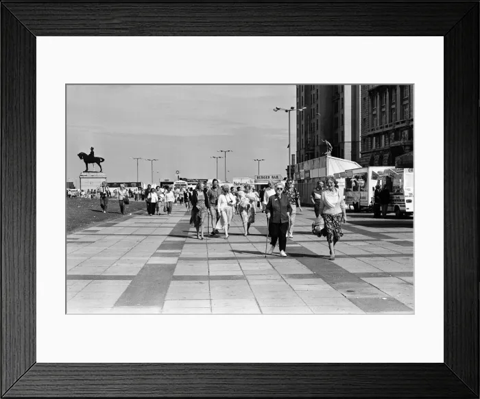 Framed Print : Crowds of people line the dock road set for a day out at Liverpool Albert Dock to see Framed Print : Crowds of people line the dock road set for a day out at Liverpool Albert Dock to see