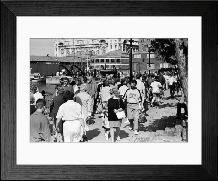 Framed Print : Crowds of people line the dock road set for a day out at Liverpool Albert Dock to see Framed Print : Crowds of people line the dock road set for a day out at Liverpool Albert Dock to see