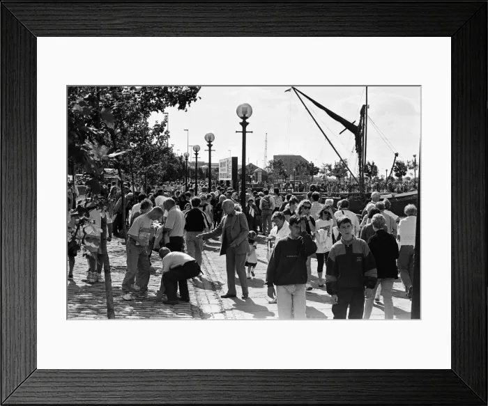Framed Print : Crowds of people line the dock road set for a day out at Liverpool Albert Dock to see Framed Print : Crowds of people line the dock road set for a day out at Liverpool Albert Dock to see