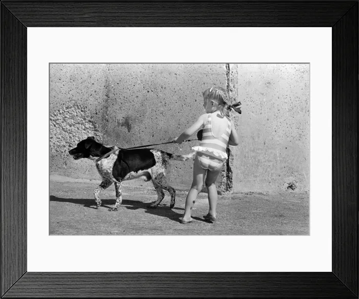 Framed Print : People enjoying a day at Crosby beach. A young girl with a dog. Crosby, Merseyside Framed Print : People enjoying a day at Crosby beach. A young girl with a dog. Crosby, Merseyside