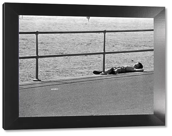 People enjoying a day at Crosby beach. A young boy sunbathing. Crosby, Merseyside