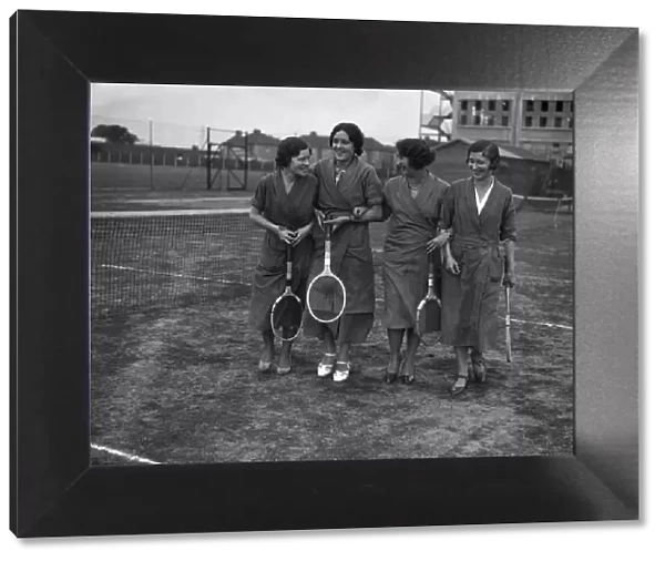 Female Hoover factory workers walking on a tennis court outside the factory building