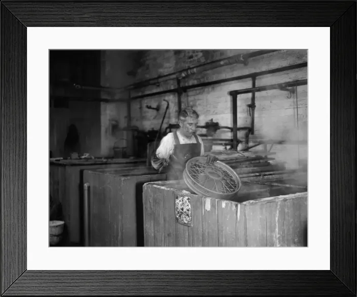 Framed Print : Wheels being dipped in chemicals in preparation for their tyres for the production line Framed Print : Wheels being dipped in chemicals in preparation for their tyres for the production line