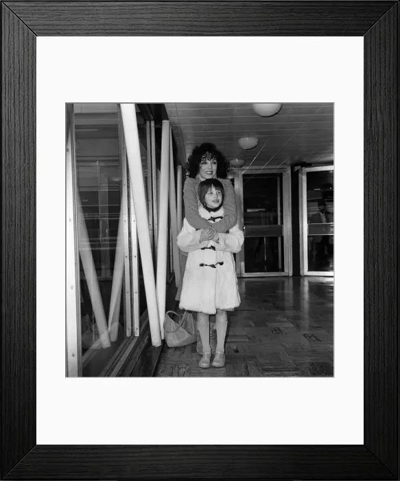 Framed Print : Joan Collins at Heathrow Airport with her daughter Katyana after a holiday in the Bahamas Framed Print : Joan Collins at Heathrow Airport with her daughter Katyana after a holiday in the Bahamas