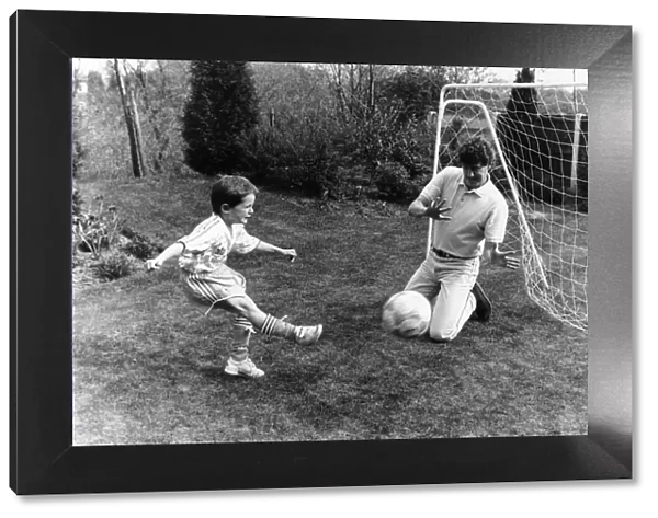 Steve Bruce, Manchester United Central Defender, playing football at home with son Alex