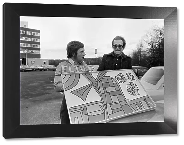 Elton John with a fan. 22nd December 1973
