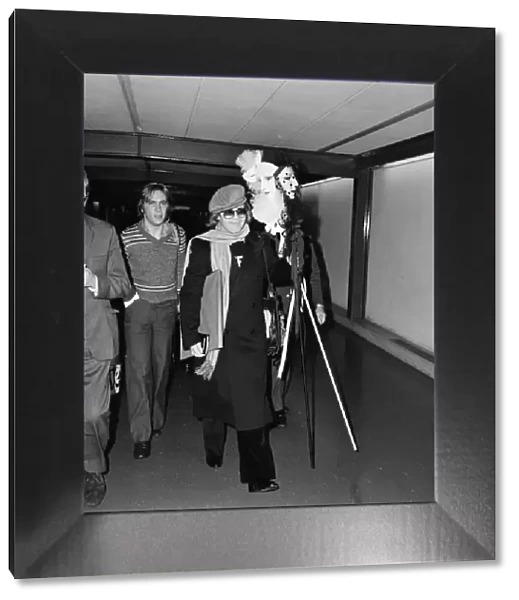 Elton John arriving at Heathrow Airport from Stockholm. 20th October 1977