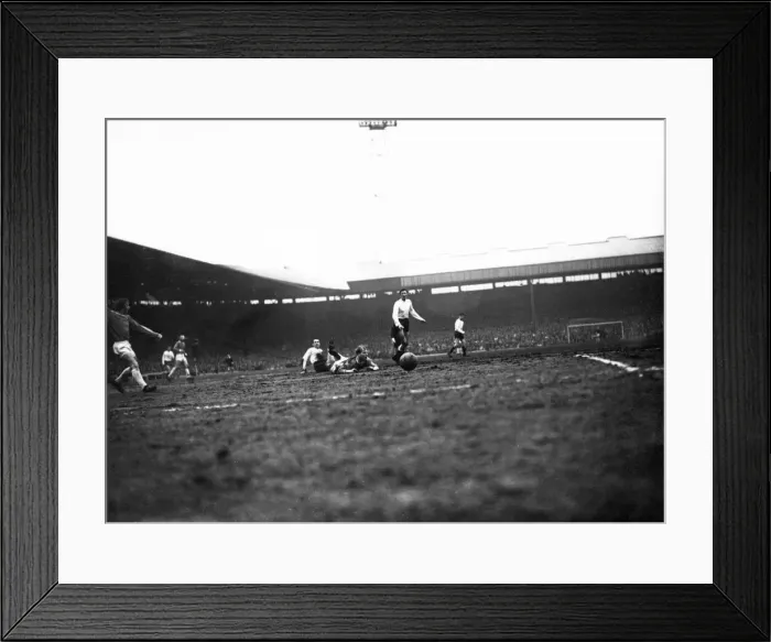 Framed Print : Bobby Charlton of Manchester United is bought down by Dave Mackay of Tottenham Hotspur