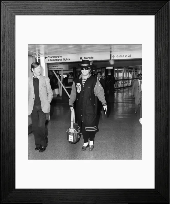 Framed Print : Elton John arriving at Heathrow Airport from Perth. 23rd December 1980 Framed Print : Elton John arriving at Heathrow Airport from Perth. 23rd December 1980
