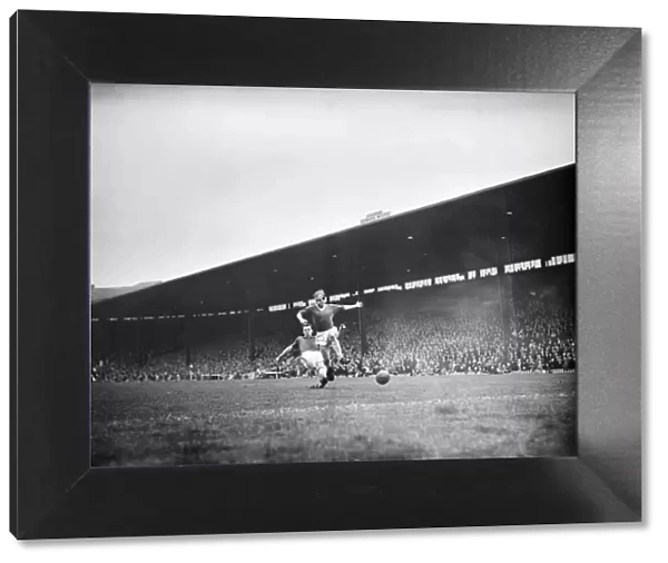Bobby Charlton leaps to elude a defender during the match between Manchester United