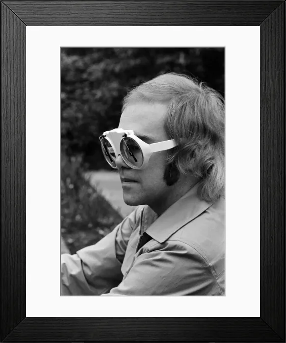 Framed Print : Elton John, singer, pictured at home in Virginia Water. He is wearing glasses which have Framed Print : Elton John, singer, pictured at home in Virginia Water. He is wearing glasses which have